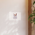 Decorative wall art with butterfly and text on a white background, leaning against a wooden surface.