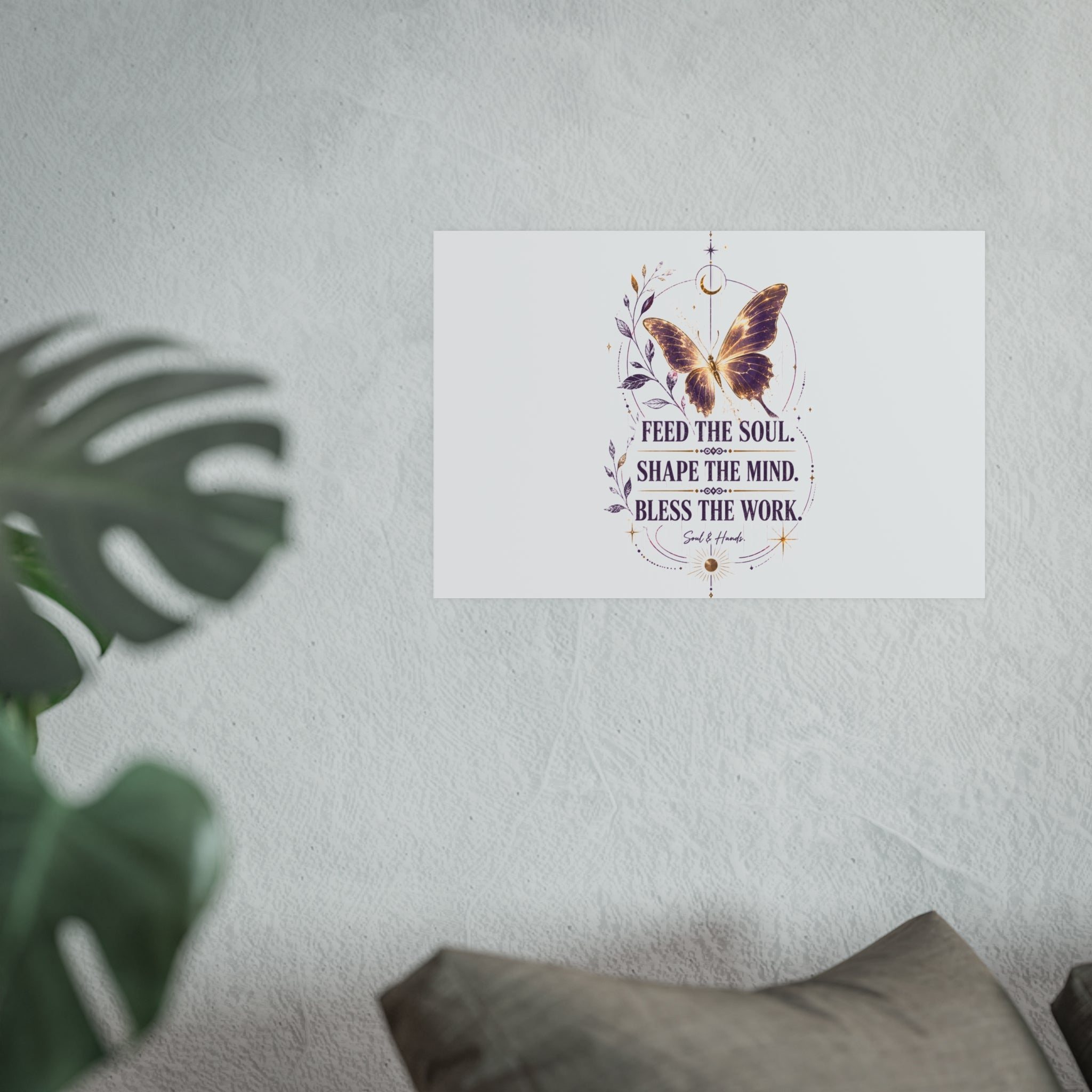 Decorative wall art with butterfly and motivational quote on a light gray wall.