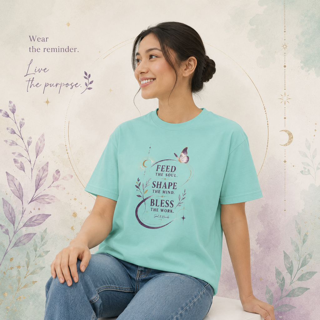 Woman wearing a turquoise Soul & Hands boxy T-shirt with purple botanical, butterfly and inspirational artwork.