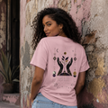Back view of a woman wearing a pink Soul & Hands T-shirt with hands, leaves, celestial symbols and an inspirational graphic.