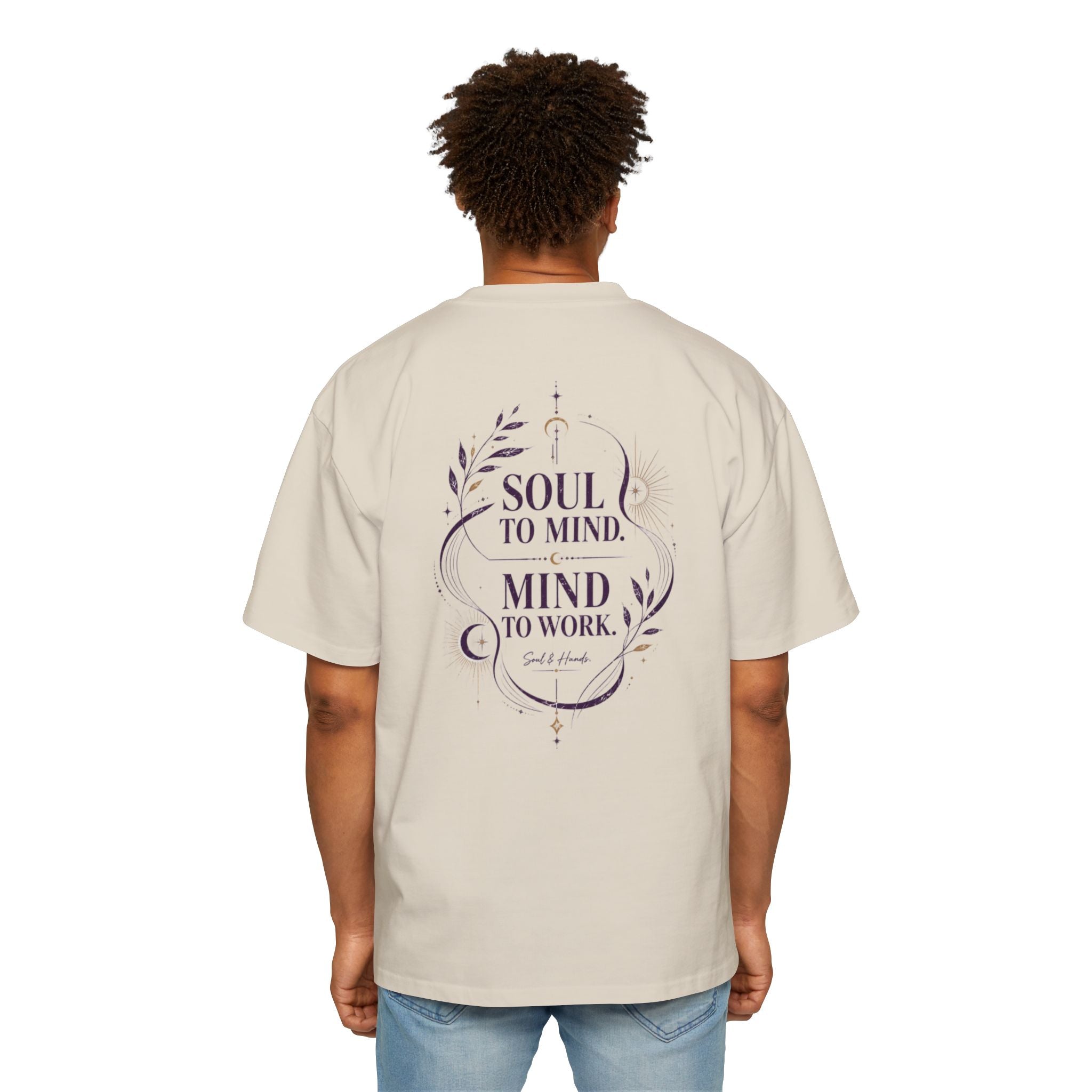 Person wearing a beige t-shirt with a motivational quote on the back, standing against a white background.