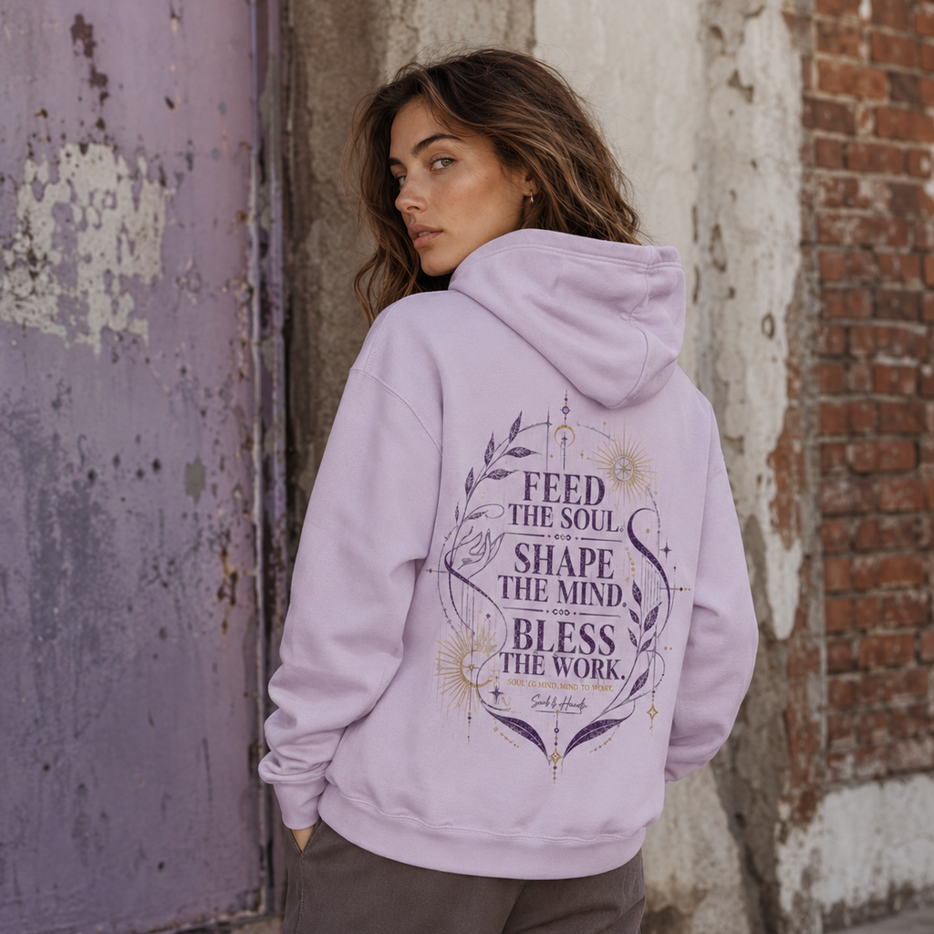 Back view of a lavender Soul & Hands hoodie with purple-and-gold Feed the Soul botanical and celestial artwork.