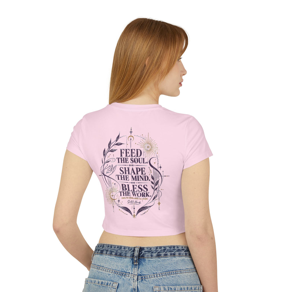 Woman wearing a pink t-shirt with text design on the back, standing against a white background